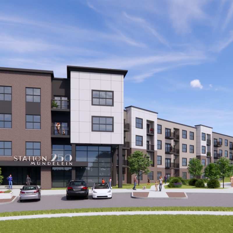 Station 250 apartment building front facade featuring brick and siding with large windows in Mundelein IL