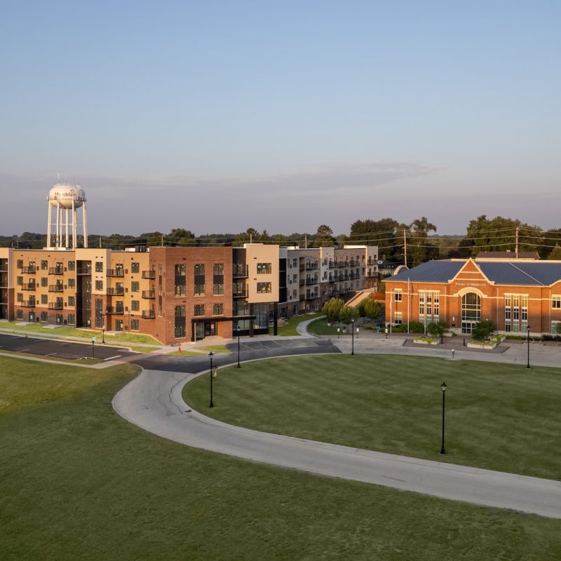 Station 250 apartment building exterior with adjacent green space and modern multi-story design in Mundelein IL