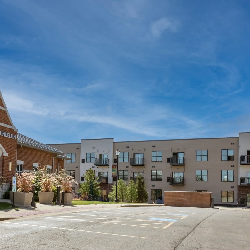 Station 250 apartment building side view showing balconies, windows, and modern exterior materials in Mundelein IL