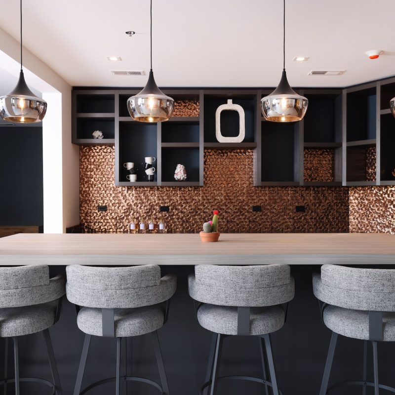 Station 250 modern bar area with high-top seating, pendant lighting, and contemporary bar design Mundelein IL