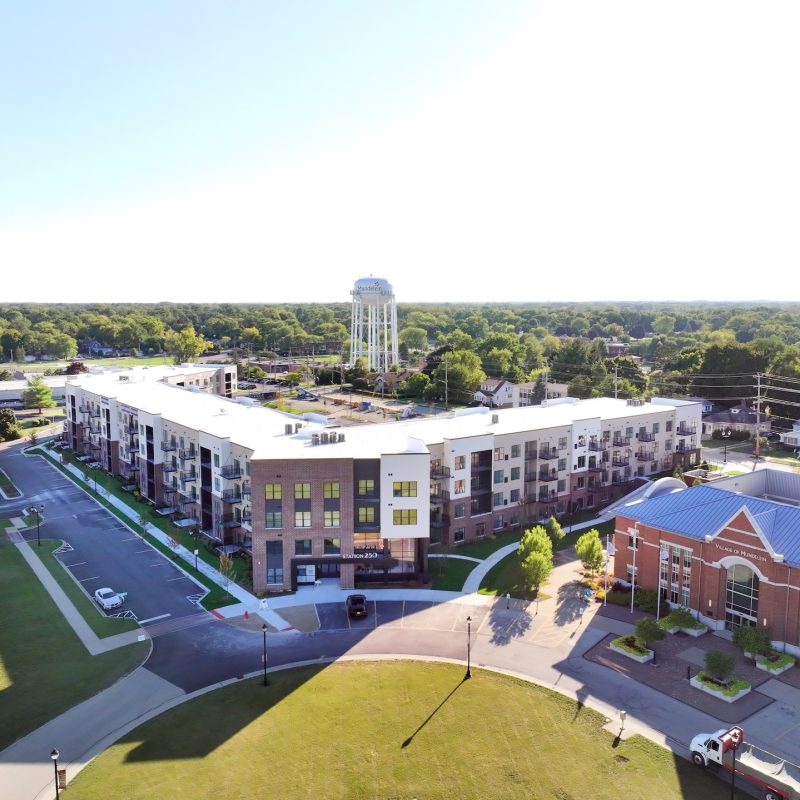 Station 250 apartment buildings aerial perspective showing rooftops and surrounding area in Mundelein IL