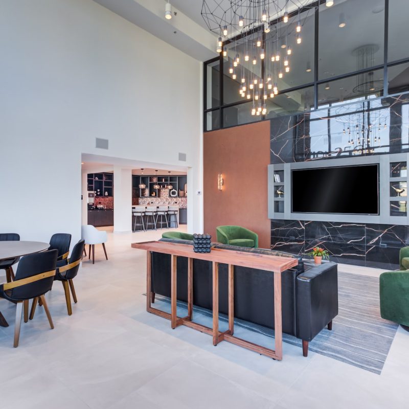 Station 250 community kitchen with large island, bar seating, and modern appliances for resident use Mundelein IL